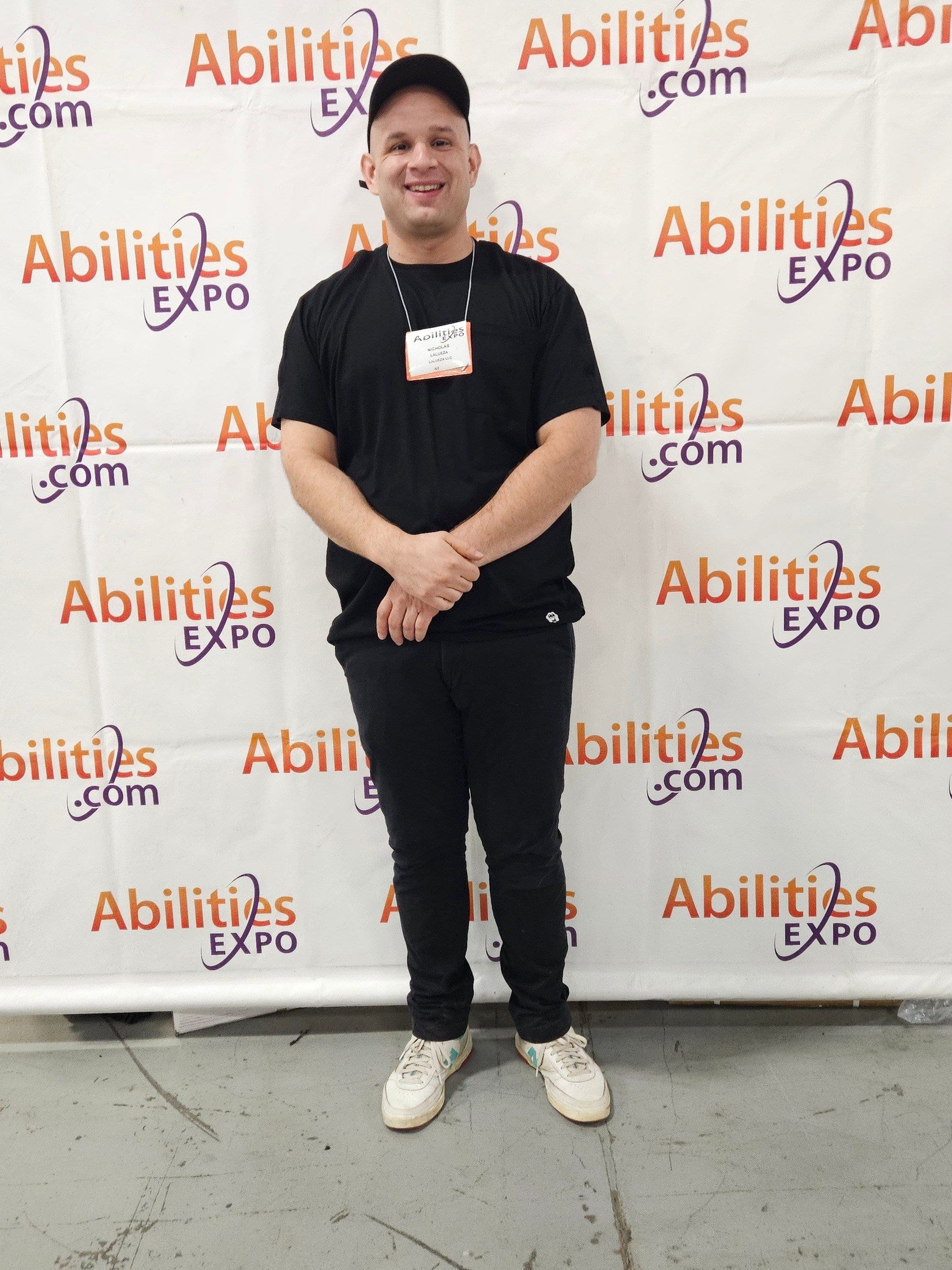 Person posing in front of an Abilities Expo backdrop