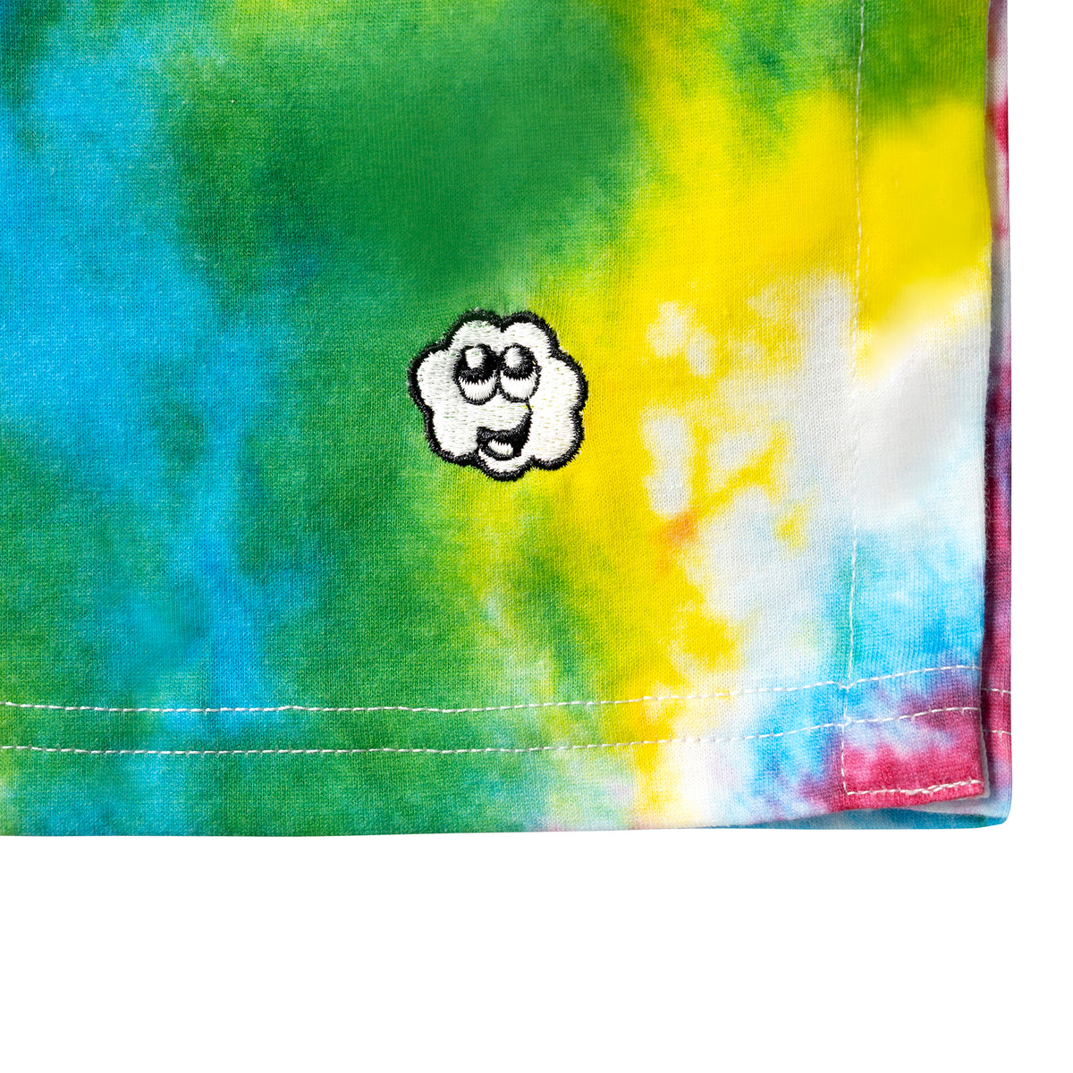 Close-up of the Happy Cloud Adaptive tie-dye T-shirt showing the Happy Cloud logo, colorful fabric, and hem stitching.
